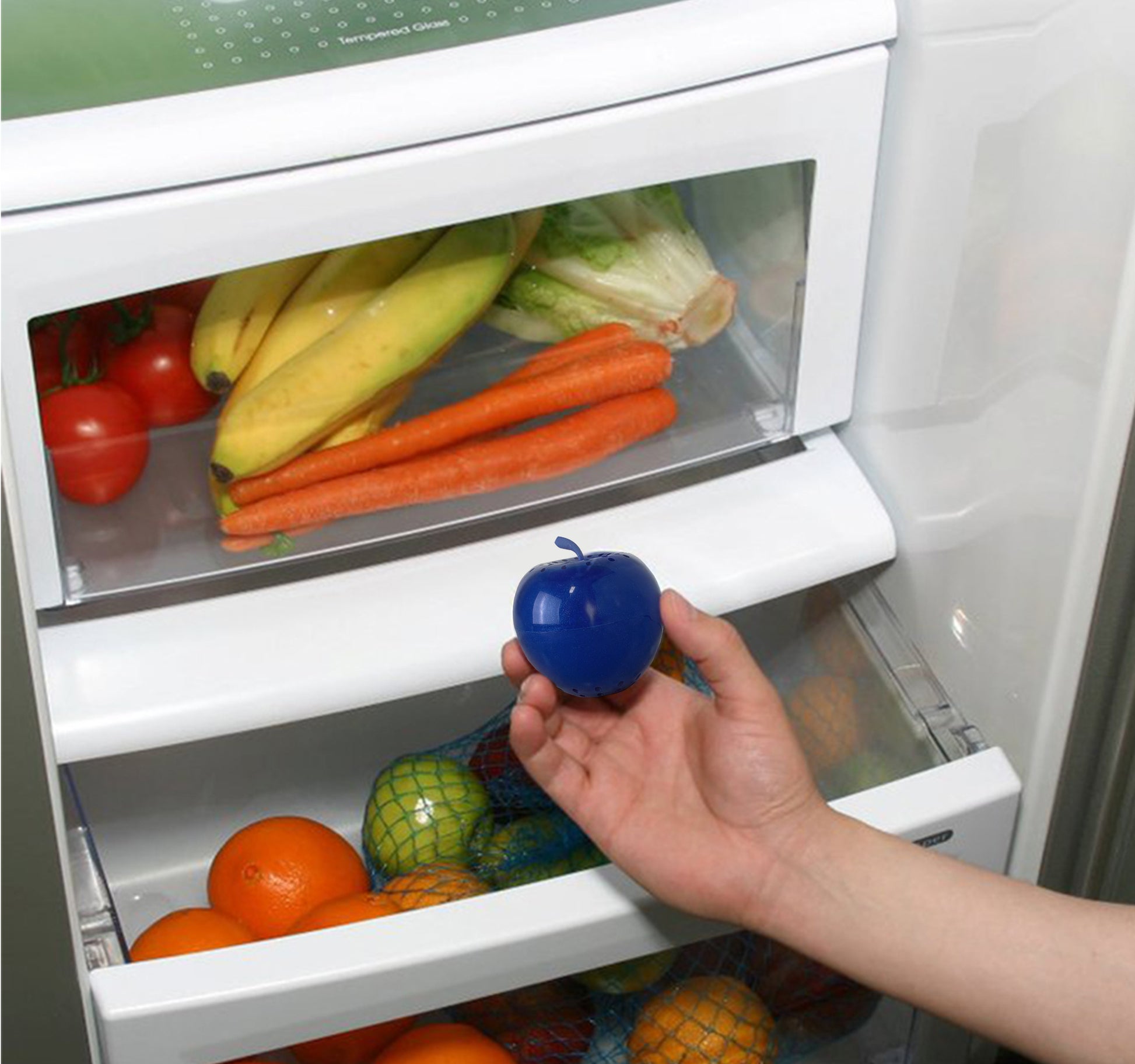 Bluapple being held over a crisper drawer