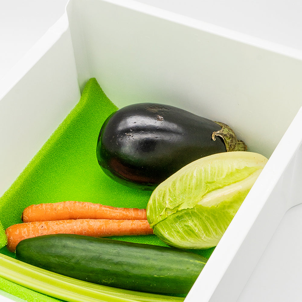 Fresh produce on green freshmat in crisper drawer