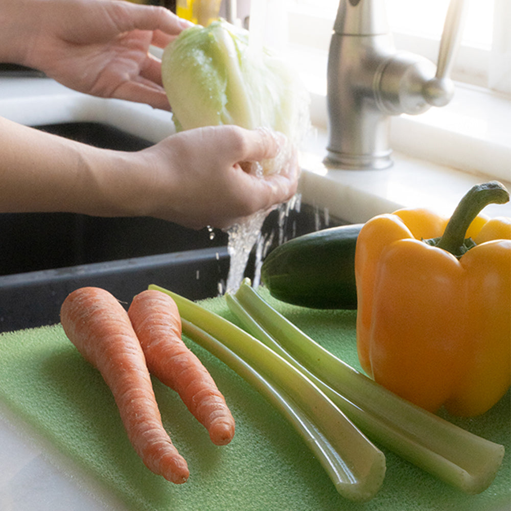 Fresh produce on green freshmat being washed