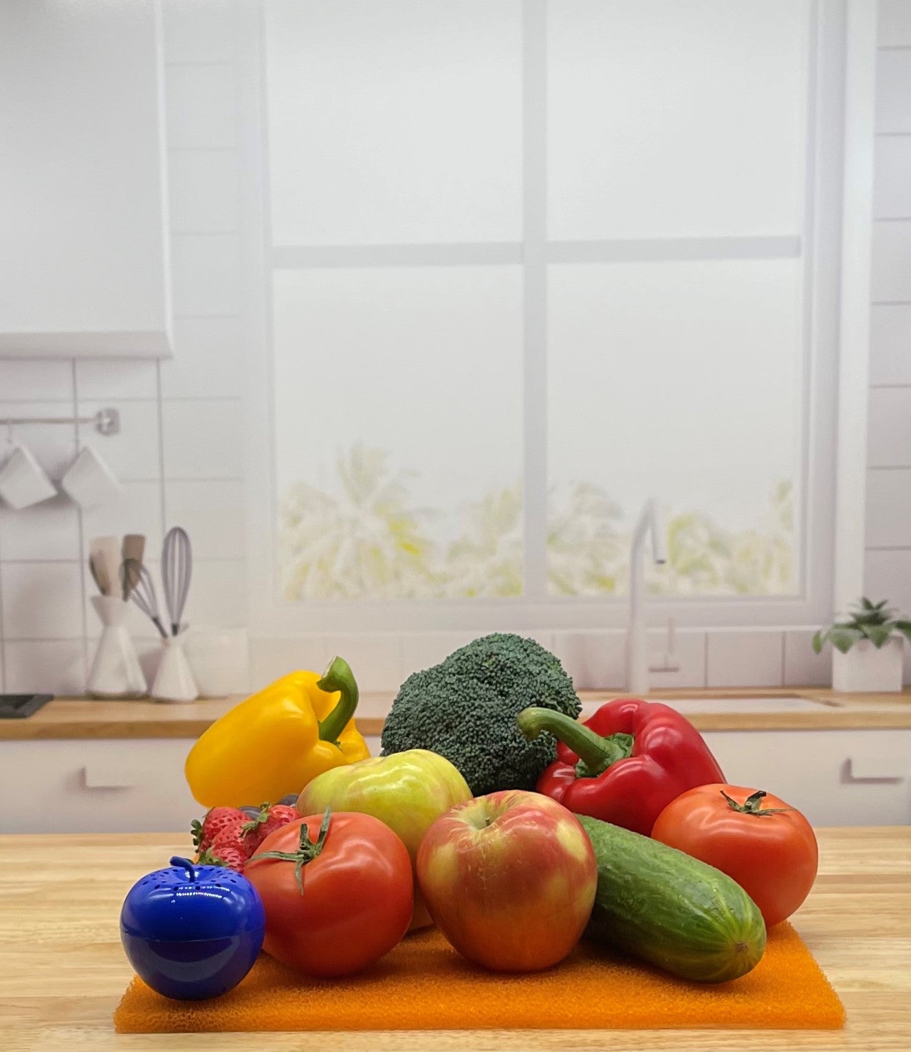 Produce on Orange FreshMat in kitchen with Bluapple